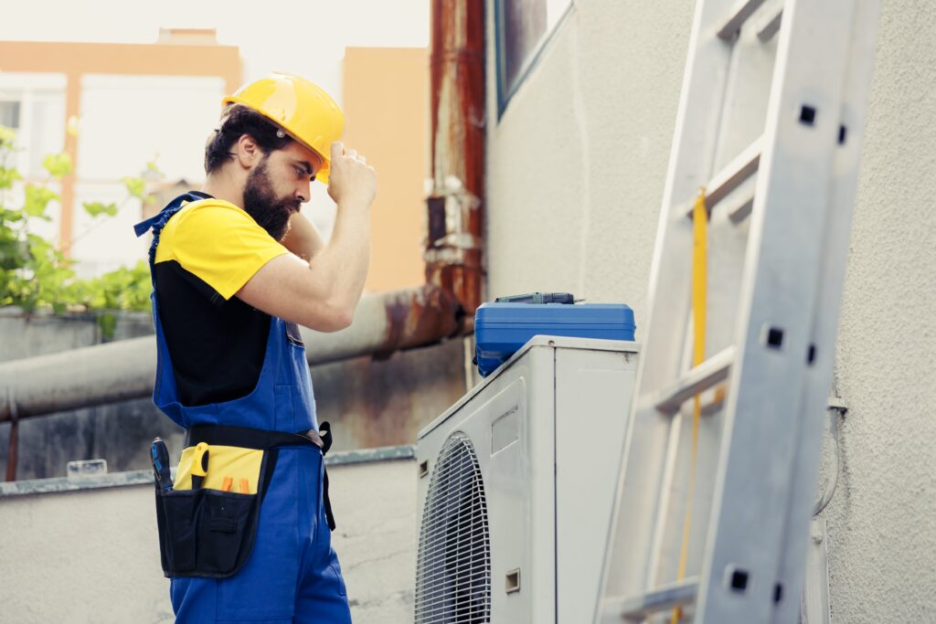 Skilled electrician contracted to check up on an outdoor air conditioner unit