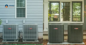 Two residential HVAC units are placed outside, against the siding of a house and in front of a window. The image conveys a neat, functional setup.