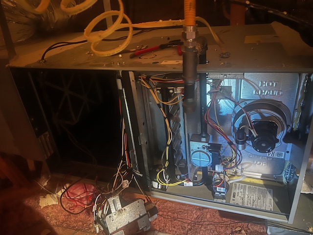 HVAC technician diagnosing burning plastic smell in McKinney, Texas